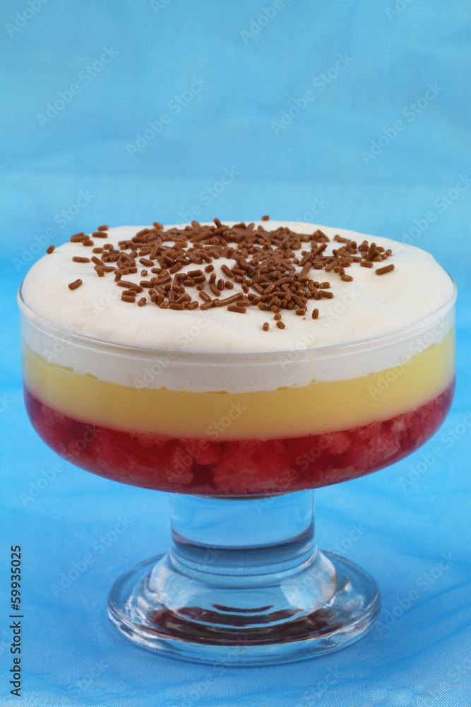 Strawberry trifle on blue background with copy space