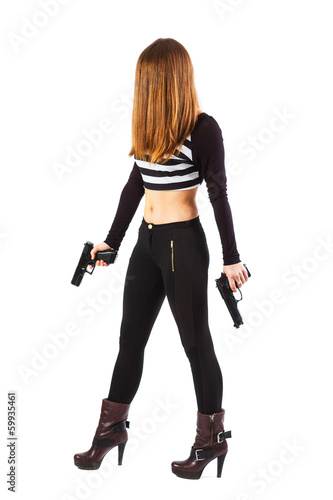 Threatening and sexy woman with guns is walking