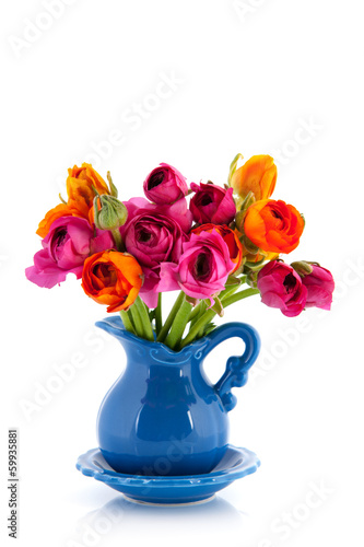 Colorful bouquet butter cups in blue vase
