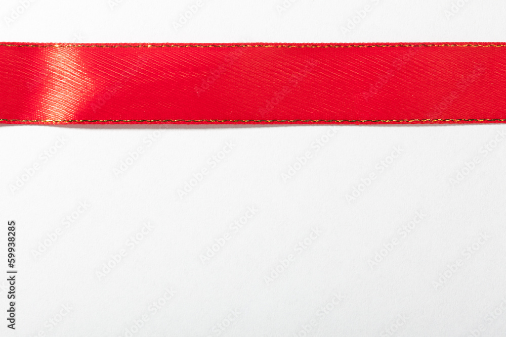 Shiny red ribbon on white background with copy space.