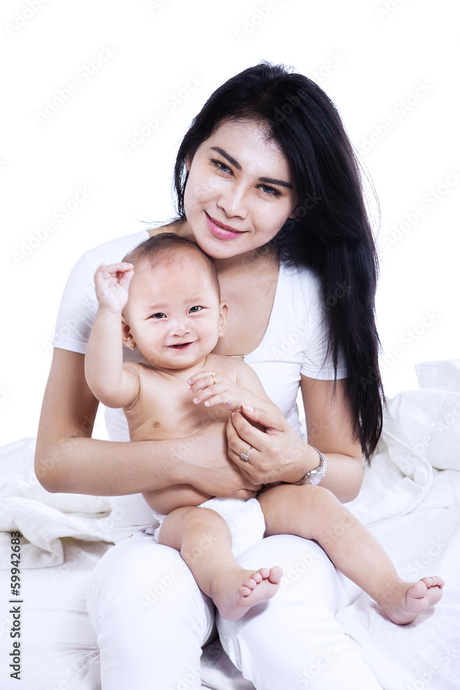 Attractive young mother and her baby isolated Attractive young mother and her baby isolated