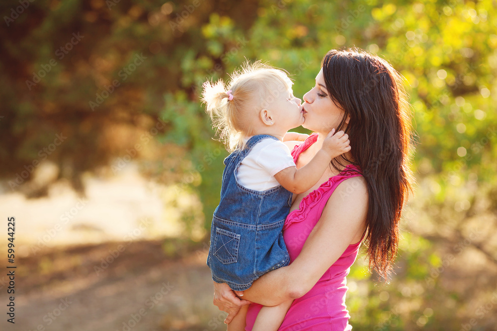 Young mother with child outside on a summer day Young mother with child outside on a summer day