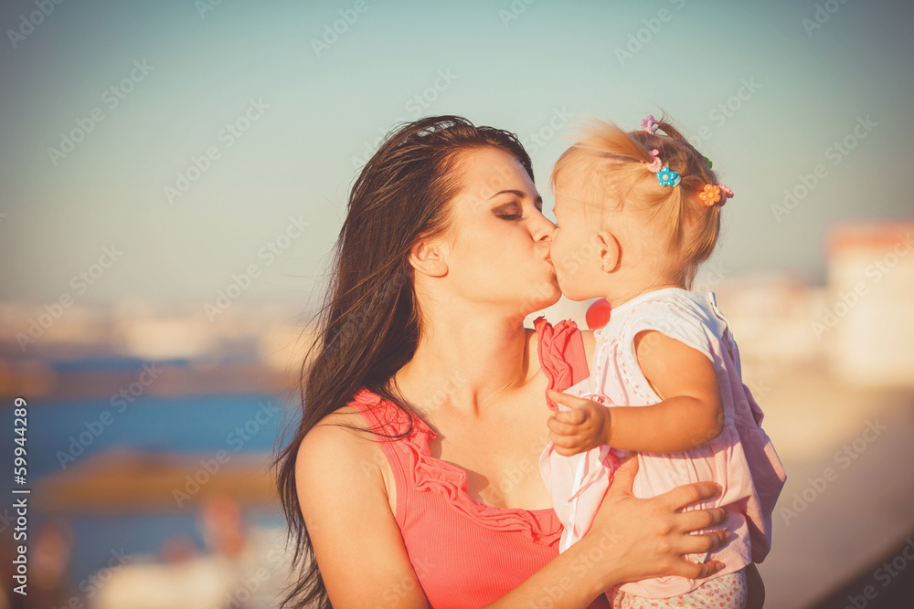 Young mother with child outside on a summer day Young mother with child outside on a summer day