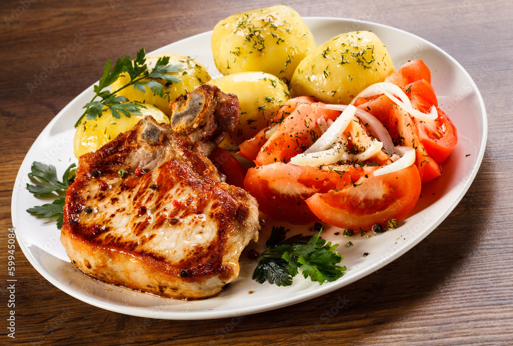 Grilled steak, boiled potatoes and vegetable salad Grilled steak, boiled potatoes and vegetable salad