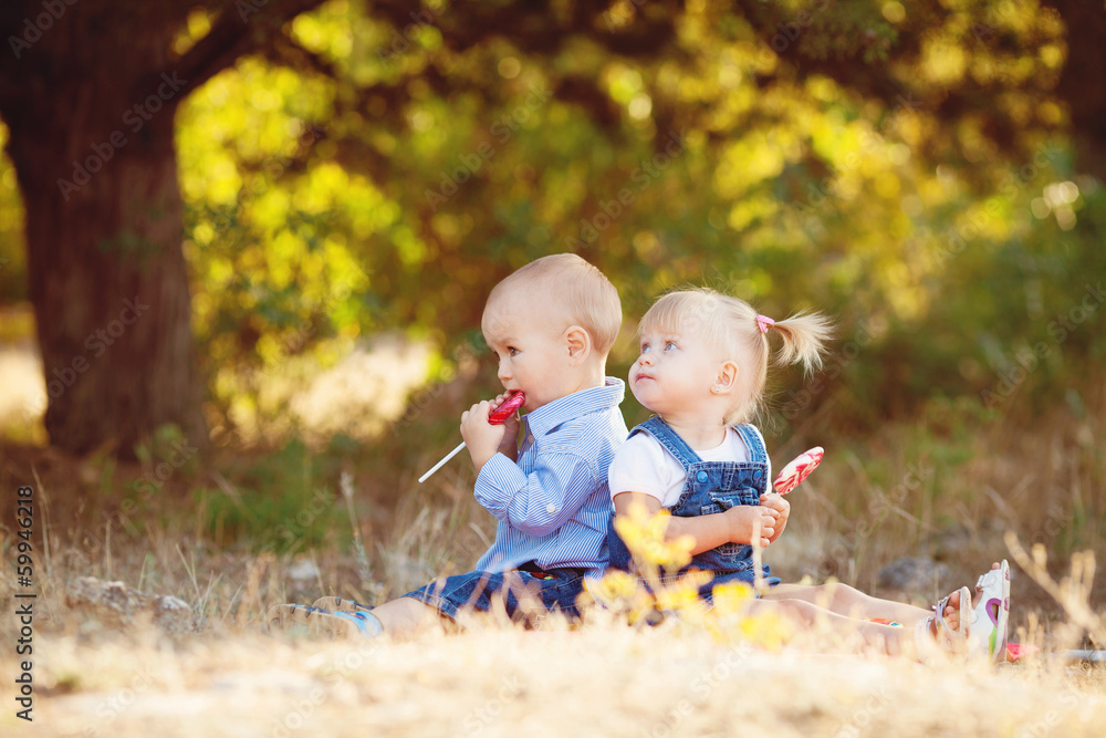 cute boy and girl playing together summer outdoors cute boy and girl playing together summer outdoors