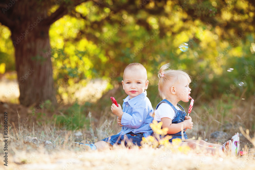 cute boy and girl playing together summer outdoors cute boy and girl playing together summer outdoors