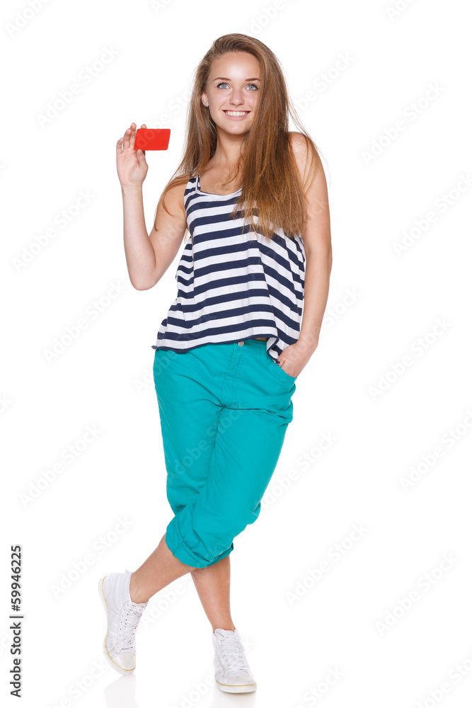 Positive teen girl smiling showing credit card Positive teen girl smiling showing credit card