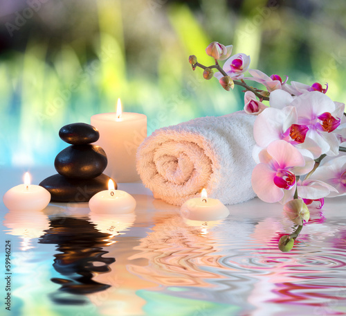 preparation for massage in white with towels, stones, in garden