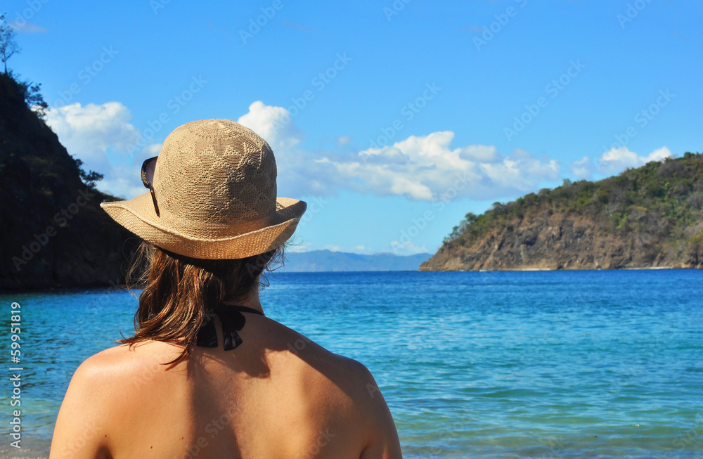 Young woman's back looking at the sea