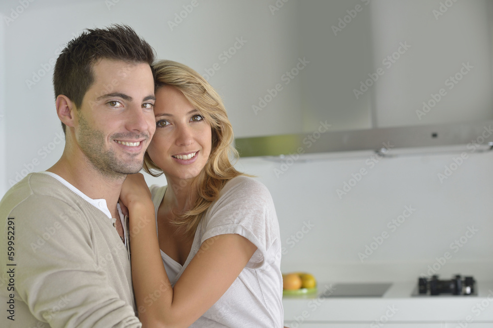 Middle-aged couple standing in home kitchen Middle-aged couple standing in home kitchen