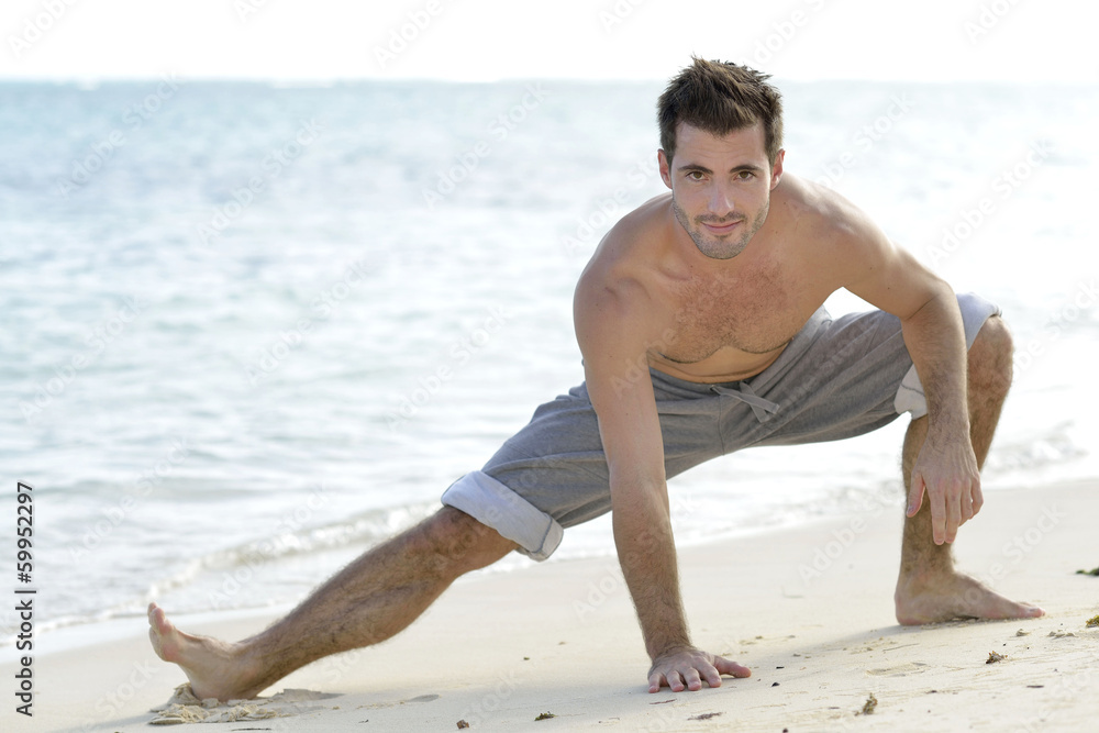 Man stretching on the beach Man stretching on the beach