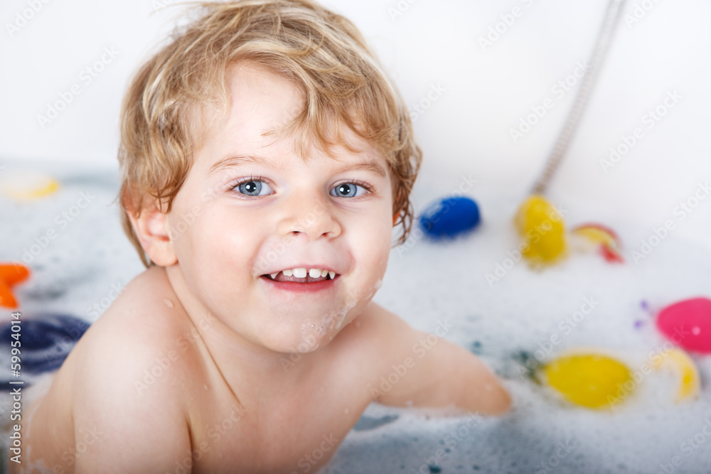 Cute little toddler boy of two years having fun by taking bath i Cute little toddler boy of two years having fun by taking bath i