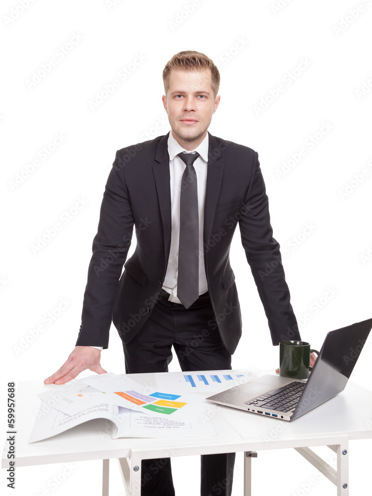 Businessman standing behind the office desk Businessman standing behind the office desk