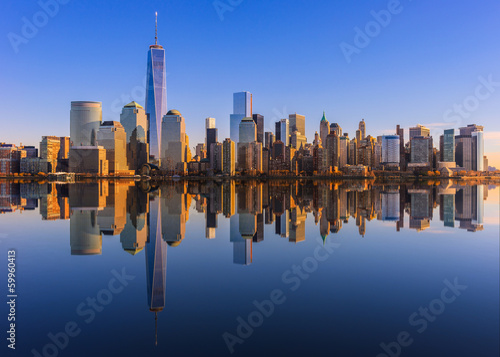 Lower Manhattan skyline panorama over East River with reflection