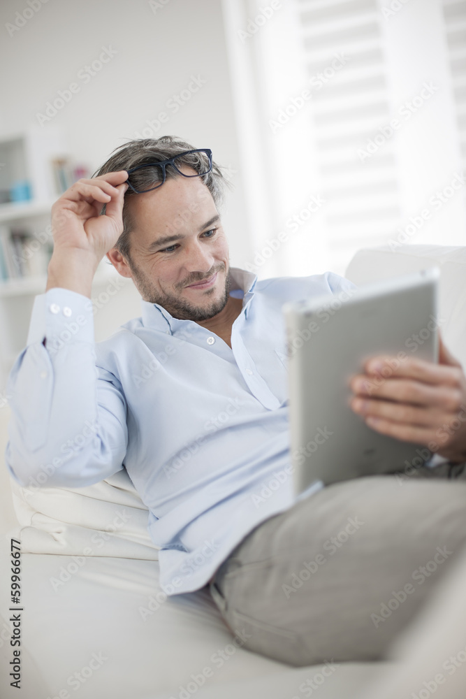 Attractive man at home using digital table