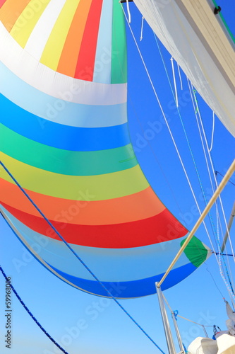 The wind has filled colorful spinnaker sail