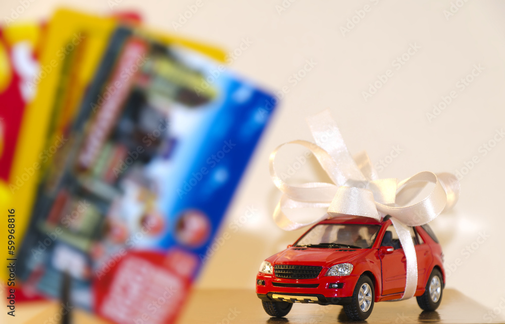 Red machine in a white ribbon and discount cards Red machine in a white ribbon and discount cards