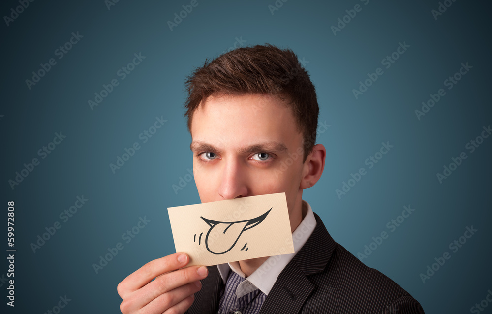 Happy businessman holding funny white card on his mouth Happy businessman holding funny white card on his mouth