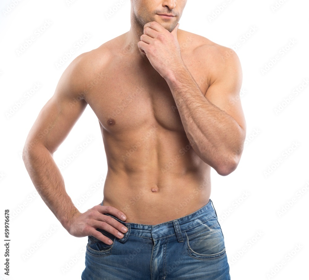 Fototapeta premium Handsome young man in blue jeans with naked torso