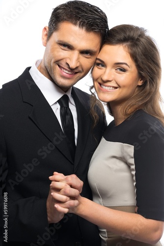 Beautiful young couple in suit and dress 