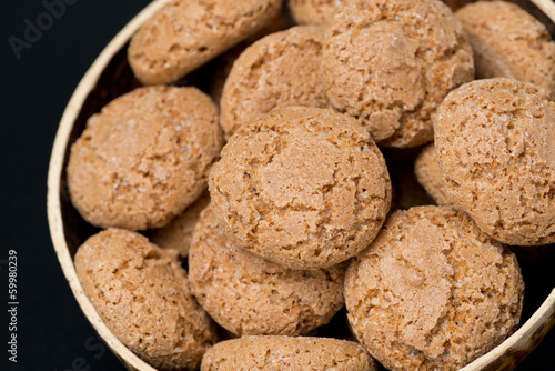 biscotti cookies in a bowl on a black background, close-up