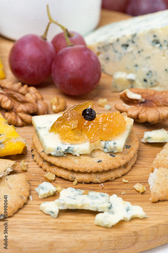 crackers with blue cheese and apple jam, nuts and grapes crackers with blue cheese and apple jam, nuts and grapes