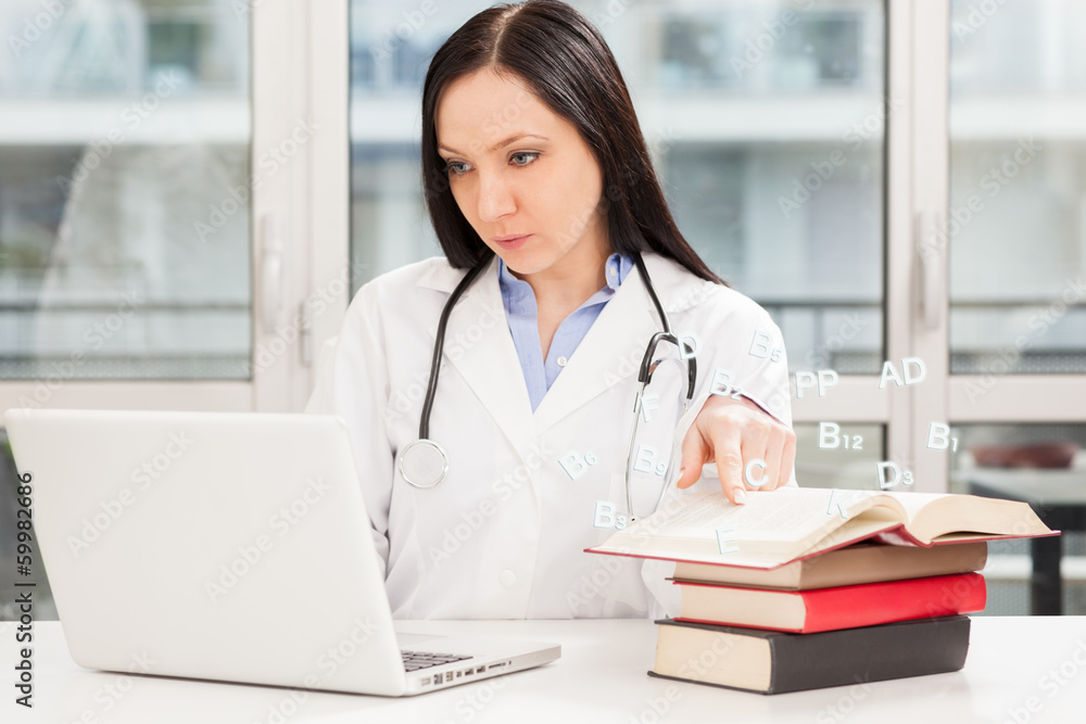 Female doctor is studying with books Female doctor is studying with books