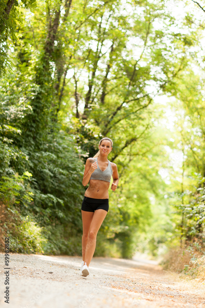 Beautiful blonde woman is doing running workout Beautiful blonde woman is doing running workout