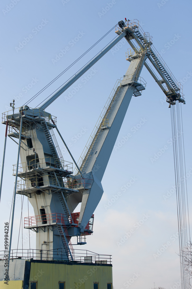 Cargo crane at a container shipping port silhouetted