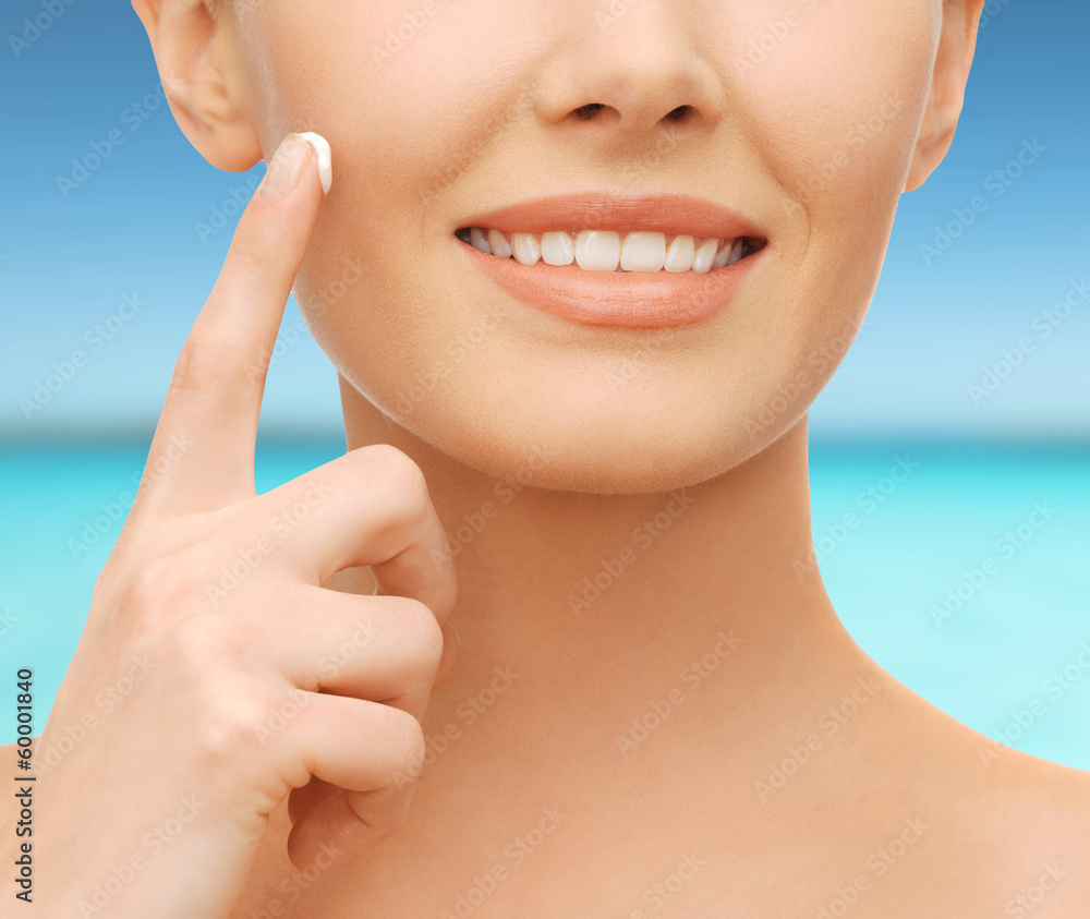 Fototapeta premium beautiful woman applying moisturizing cream