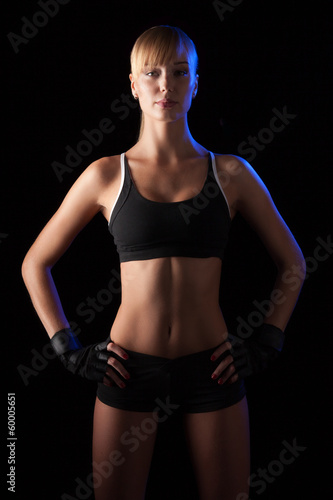 athletic woman over dark background
