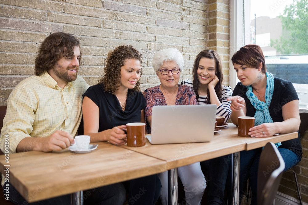 Woman With Friends Using Laptop At Coffeeshop Woman With Friends Using Laptop At Coffeeshop