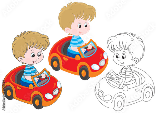 boy riding in a toy car
