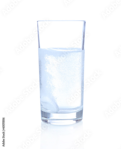 Glass with efervescent tablet in water with bubbles isolated