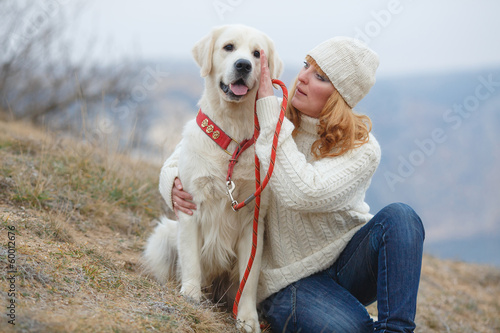 Beautiful girl with her dog near sea