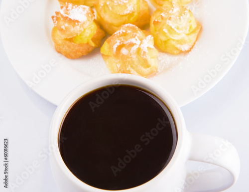 Homemade cream puff and a mug of coffee photo