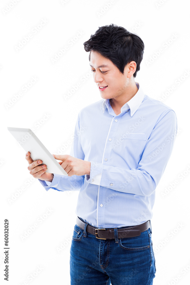 young Asian man having a smard pad PC young Asian man having a smard pad PC