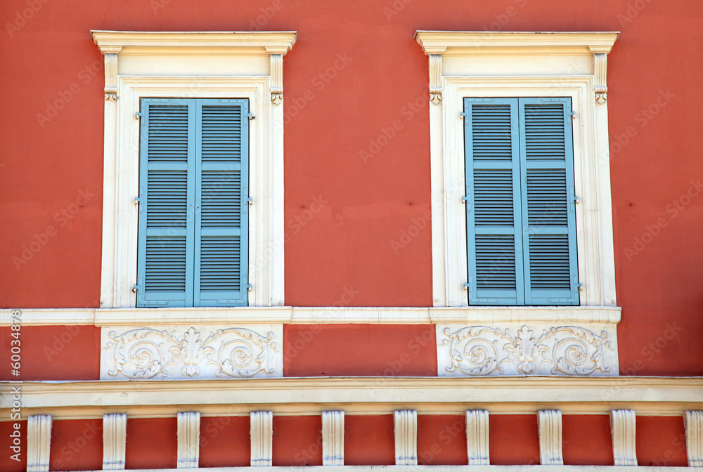 old french blue shutter windows in red house, Nice, France.