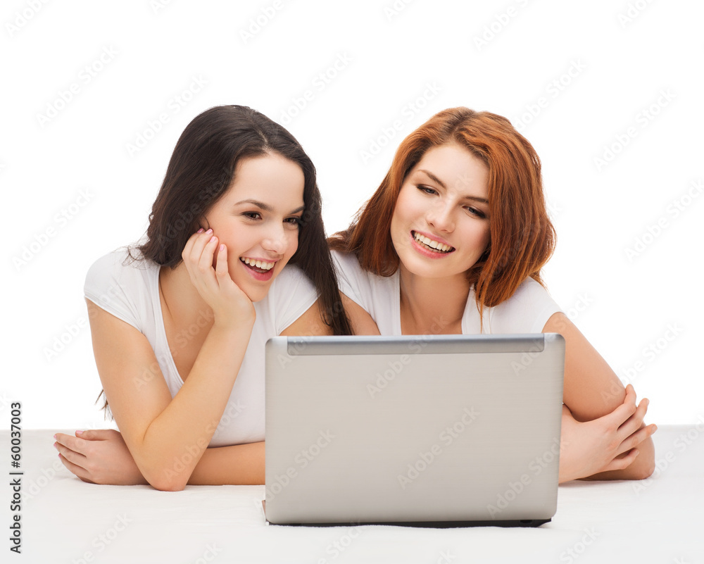 two smiling teenage girls with laptop computer two smiling teenage girls with laptop computer