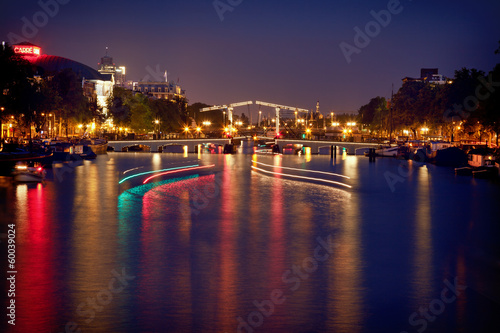Colorful Reflection of Magere Brug Bridge in Amsterdam at Night