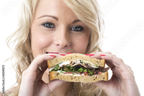 Attractive Young Woman Eating a Sandwich