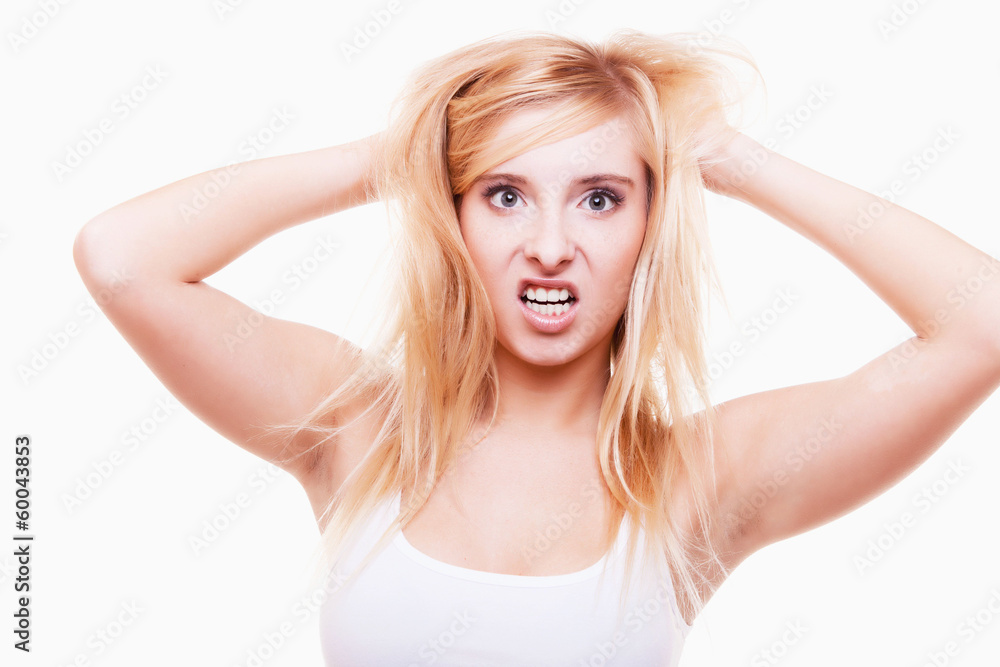 Stress. Young woman frustrated pulling her hair on white