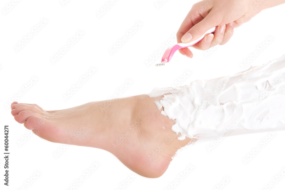 Beautiful woman is shaving her legs with razor and foam. Beautiful woman is shaving her legs with razor and foam.