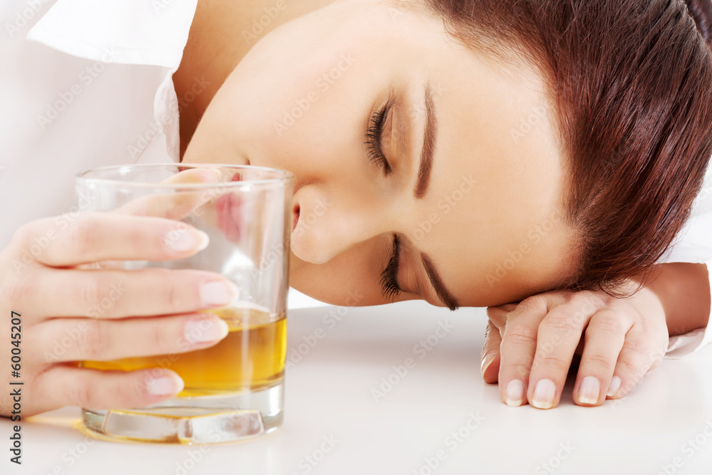 Young beautiful business woman with glass of whisky or rum. Young beautiful business woman with glass of whisky or rum.
