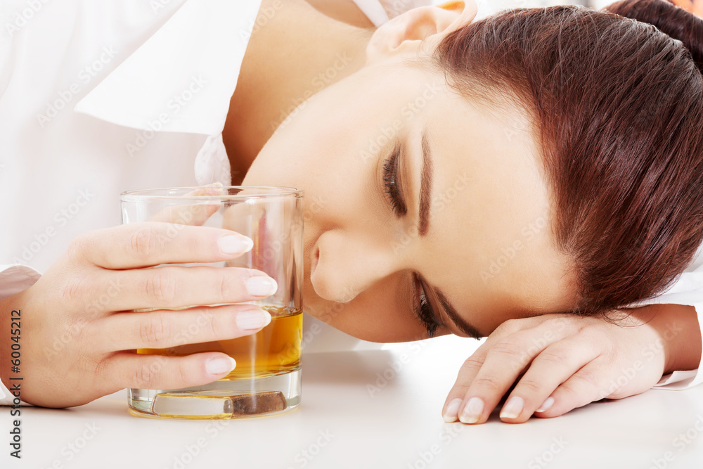 Young beautiful business woman with glass of whisky or rum. Young beautiful business woman with glass of whisky or rum.