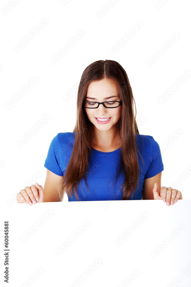 Young beautiful casual woman holding copy space. Young beautiful casual woman holding copy space.