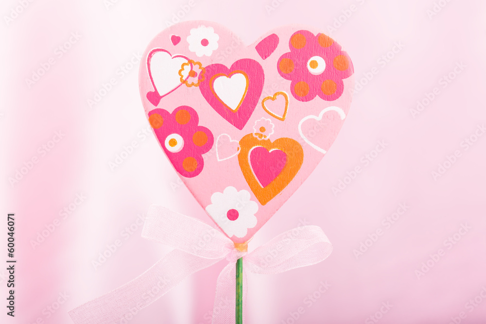 Pink handmade heart over pink background