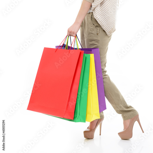 shopping girl, young woman on high heels with colored shopping b