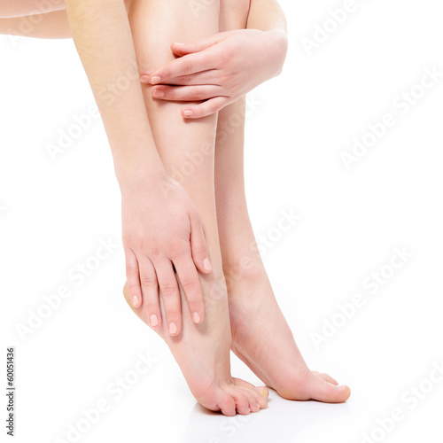 beautiful graceful female legs of young woman over white