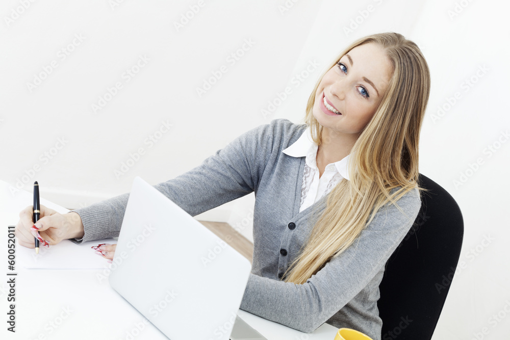Business woman sitting at a desk office computer Business woman sitting at a desk office computer